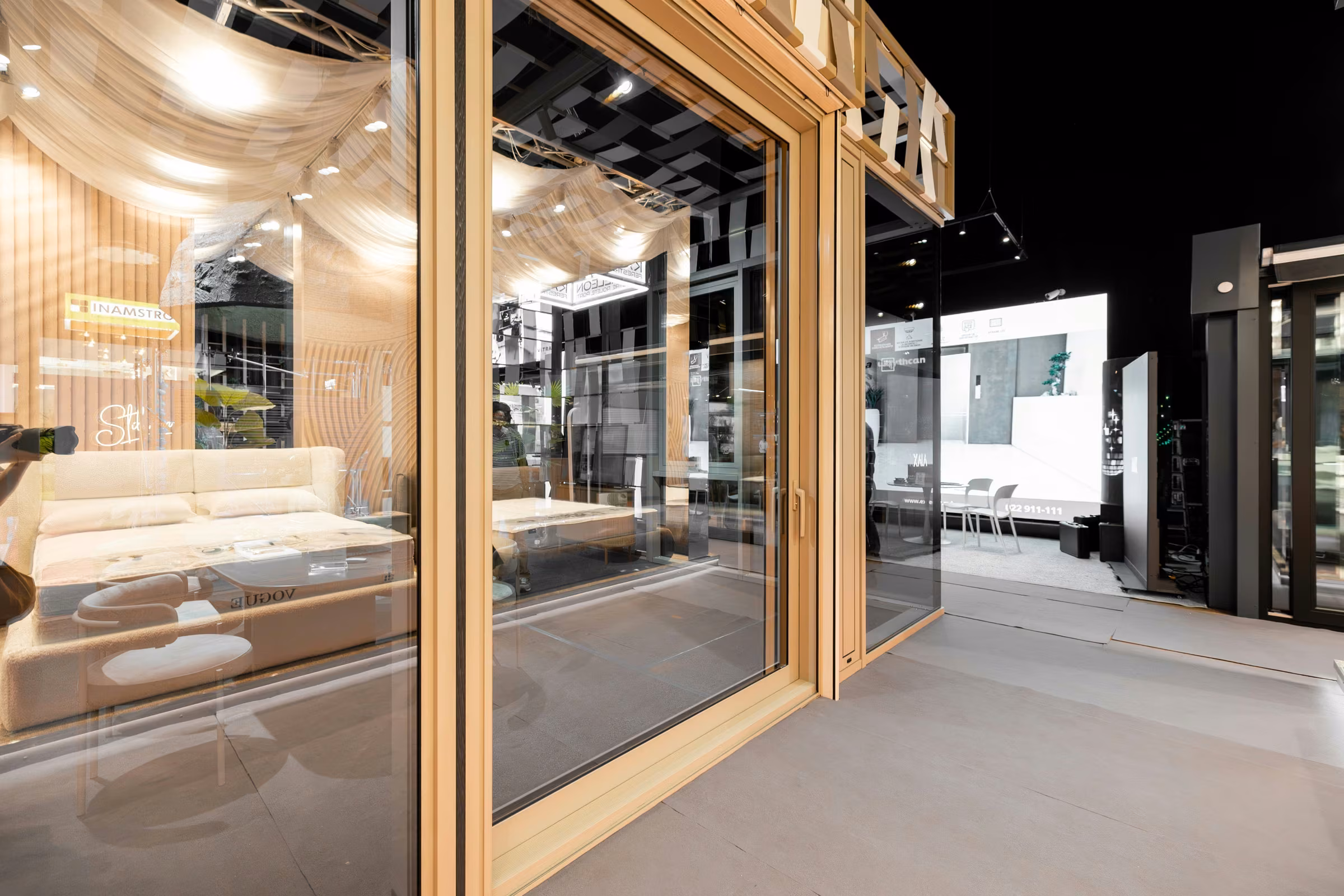 Glazed exhibition stand frontage with aluminium frames and display areas visible inside.